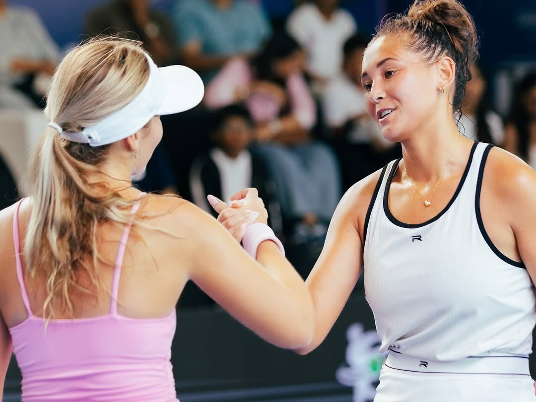 two professional pickleball players greeted each other after the game