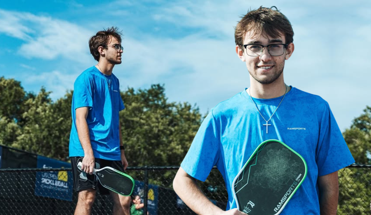 Pickleball player Connor Duvall in a blue Ramsports tee, holding a green Ramsports paddle courtside