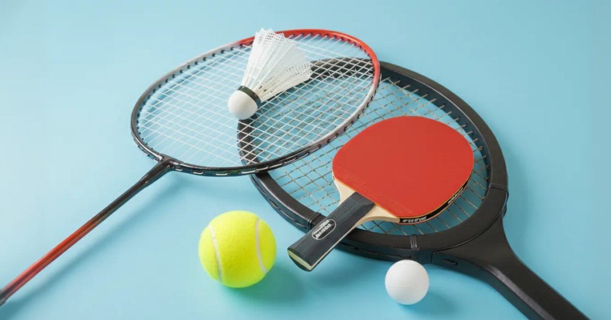 Tennis racket, badminton racket, and table tennis paddle stacked together with their balls
