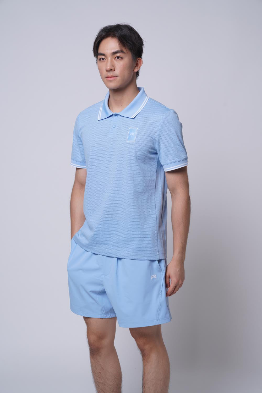 Male model standing sideways, hands on pocket, wearing Ramsports MatchDay Core Short in blue